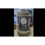 An Onyx Mantle Clock with mercury pendulum and ormolu mounts, with pillar supports of
