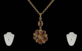 Ladies Attractive 9ct Gold Garnet and Black Seed Pearl Set Pendant, Attached to a 9ct Gold Chain.