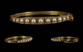 Victorian Period 1837 - 1901 Ladies 15ct Gold Pearl Set Hinged Bangle with Safety Chain. Tests