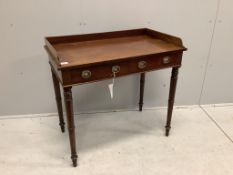 A Regency mahogany two drawer dressing table with a galleried top, on ring turned legs, width