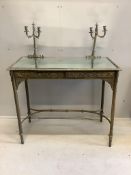 An early 20th century mirrored, embossed brass dressing table, width 96cm, depth 48cm, height 118cm.