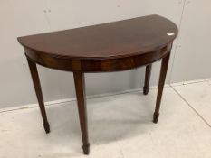 A George III style mahogany demi-lune console table on tapered legs and spade feet, width 114cm,