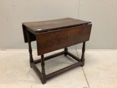 A 17th century rectangular oak drop leaf table on turned legs stretcher rail, label with '165' on