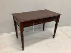 An early 20th century mahogany writing table with two frieze drawers with brass ring handles on