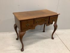 An 18th century style oak kneehole dressing table on cabriole legs, width 105cm, depth 53cm,