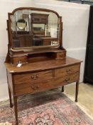 An early 20th century mahogany bowfront dressing table, fitted two short and one long drawer with