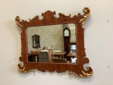 A George II style parcel gilt mahogany fret cut wall mirror, width 89cm, height 70cm. Condition -