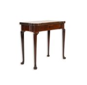 A George II mahogany card table with satinwood banded serpentine folding top enclosing a baize lined