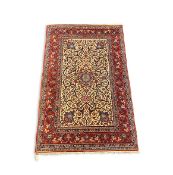 An Isfahan Persian ivory ground rug, with central medallion and field of scrolling foliate motifs,