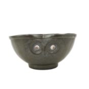 Liberty & Co., a Tudric pewter bowl, modelled with the masks of three owls, the eyes inset with