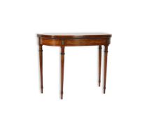 A Regency rosewood banded and painted satinwood card table with folding D shaped top, the frieze and