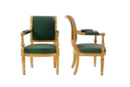 A pair of Louis XVI style giltwood fauteuil with foliate carved frames and green silk upholstered