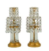 A pair of Victorian ormolu and cut glass lustre candlesticks with two tiers of circular facetted