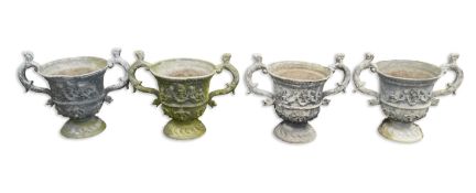 A set of four 18th / 19th century lead urns, with animal head scroll handles, the sides applied with