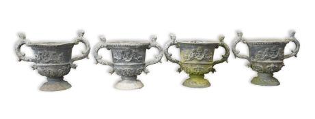 A set of four 18th / 19th century lead urns with animal head scroll handles, the sides applied