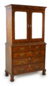 An early 18th century figured and burr walnut cabinet on chest, with moulded cornice and two