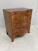 A small reproduction mahogany serpentine chest, with slide, width 60cm, depth 39cm, height 71cm.