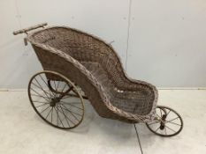 A 19th century wrought iron and wicker invalid's chair, width 60cm, height 88cm. Condition - fair to