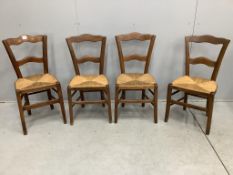 Four French cherry rush seat dining chairs, height 84cm. Condition - fair to good