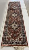 A North West Persian style red ground runner, 280 x 79cm. Condition - fair