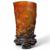 A Chinese buffalo horn vessel, on carved wood stand, 13cm high including stand. Condition - good