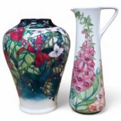 A Moorcroft ‘Nostalgia’ pattern vase together with a similar ‘Foxglove’ pattern ewer, 24.5cm.
