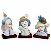 Three Lladro porcelain clown busts on plinths, largest 33cm high. Condition - good