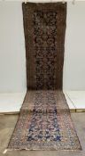 An antique Hamadan blue ground runner, approximately 460 x 110cm. Condition - poor