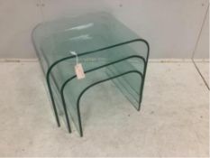 A nest of three Contemporary curved glass tables, width 59cm, depth 44cm, height 45cm. Condition -