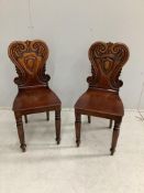 A pair of Victorian mahogany hall chairs, width 37cm, height 84cm. Condition - fair