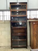 A Globe Wernicke style oak seven section glazed bookcase with secretaire, width 87cm, depth 31cm,
