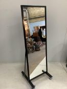An industrial style metal robing mirror, on wheeled base, width 63cm, height 190cm. Condition -