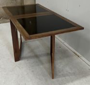 An Arne Robberts mid century Danish teak and laminate folding coffee table, width 103cm extended,