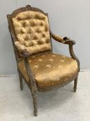 A late 19th century French Louis XVI style carved giltwood and composition elbow chair, width