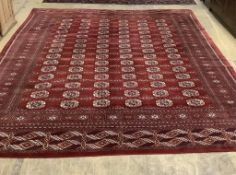 A Bokhara burgundy ground carpet, approximately 350 x 280cm. Condition - good