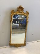 A George II style giltwood wall mirror with engraved plate, width 43cm, height 108cm. Condition -