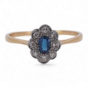 A 1920's yellow metal, stamped 18ct, sapphire and diamond set oval cluster ring, size V, gross weigh