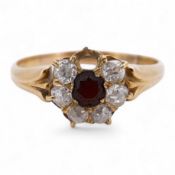 A yellow metal, garnet? and diamond set circular cluster ring (one stone missing), size P, gross wei