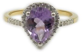 A modern 18ct gold and single stone pear cut amethyst set ring, with diamond chip set border and sho