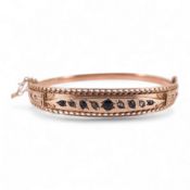 An Edwardian 9ct gold, sapphire and diamond set hinged bangle, Chester, 1909, interior diameter 57mm