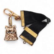 A late Victorian yellow metal overlaid and citrine set watch key fob, depicting two horses and two r