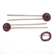 A Victorian yellow metal and garnet cluster set open work brooch, 27mm, together with two garnet clu