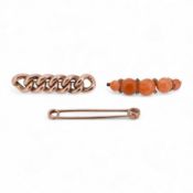 An early 20th century yellow metal and graduated five stone coral bead brooch, with seed pearl space