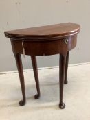 A small George II and later demi lune folding mahogany tea table, width 64cm, depth 32cm, height 70c