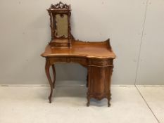 A Continental Art Nouveau carved walnut dressing table, width 92cm, depth 56cm, height 134cm. Condit