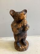 A garden chain saw carving of a standing bear together with a painted reconstituted stone Captain Ma