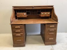 An early 20th century oak roll top desk with 'S' shaped tambour, width 140cm, depth 81cm, height 122