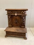 An 18th century style Continental carved walnut prie dieu cabinet, width 72cm, depth 49cm, height 90
