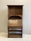 An Arts and Crafts brass mounted oak bureau bookcase, width 84cm, depth 38cm, height 185cm. Conditio