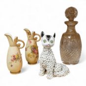 A pair of Worcester blush miniature ewers, an Italian pottery cat and a glass decanter and stopper,